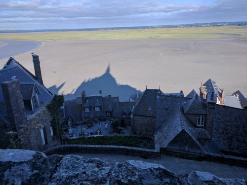 A view from within Mont Saint Michel, overlooking a cemetery, town and the mudflats