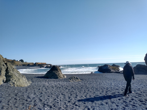 Enjoying the hot massaging of the rocks at Black Sands Beach, California