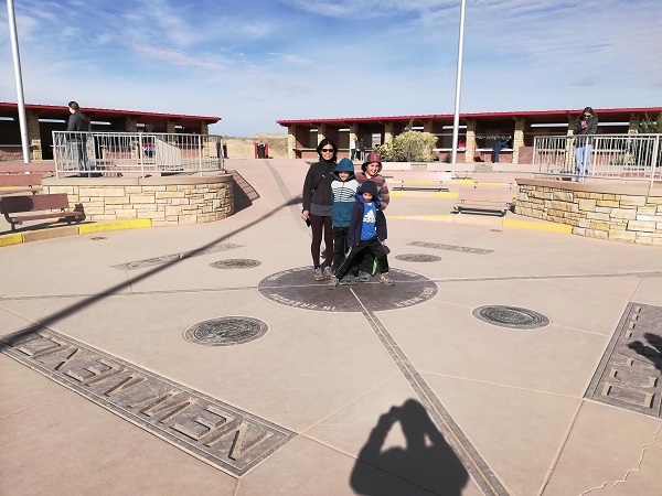 Trying to stand on all four states, Four Corners Monument, AZ,UT,CO,NM