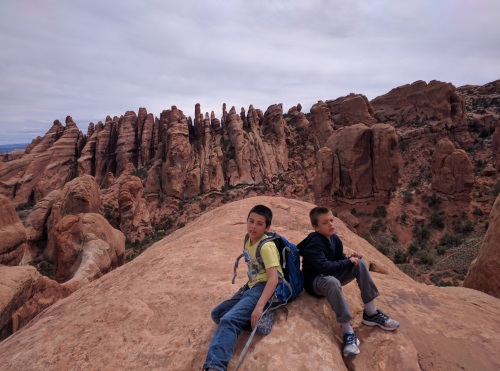 Sitting on a fin for a panorama of fins across the valley, near Private Arch, Arches NP, UT