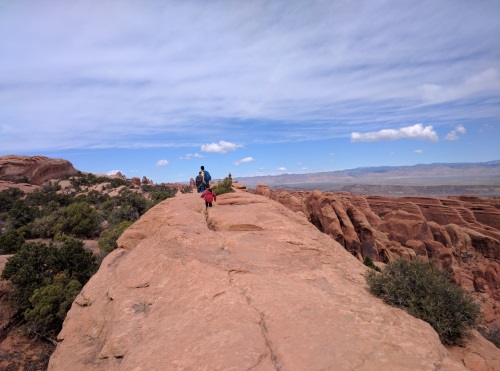 Walking on a fairly flat fin (read ledge) towards Double O Arch, Arches NP, UT