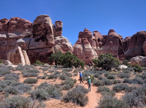 Walking between rock complexes, Chesler Park-Joint Trail, Needles District, Canyonlands NP, Utah