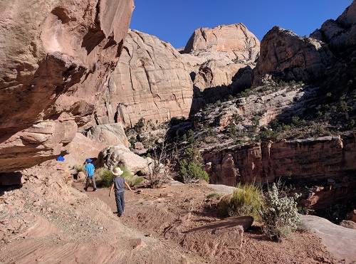 Walking along a ledge on the Golden Throne Trail, Capitol Reef NP, UT